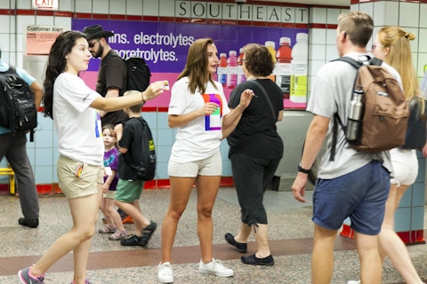 Representatives pass out vitaminwater farecards to CTA commuters