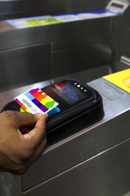 Person scans vitaminwater card to enter Chicago station