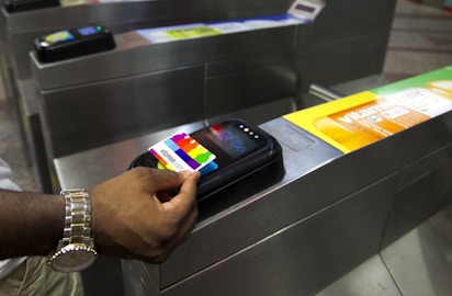 Person scans vitaminwater card to enter Chicago station