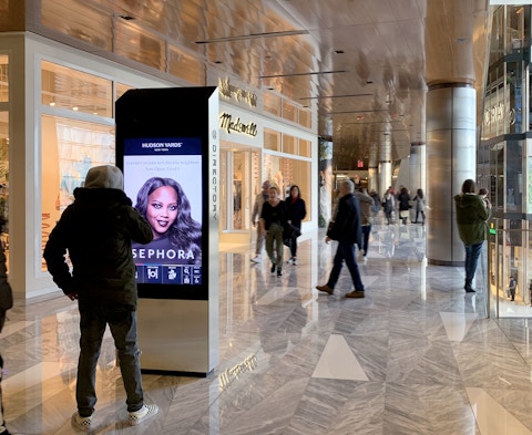 Visitor views advertisement and interacts with kiosk at Hudson Yards
