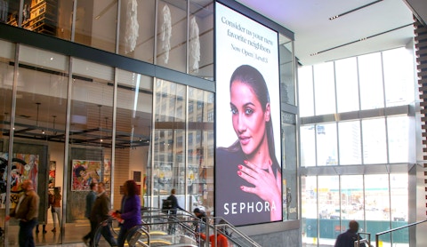 People walking by large format digital display at entrance to Hudson Yards