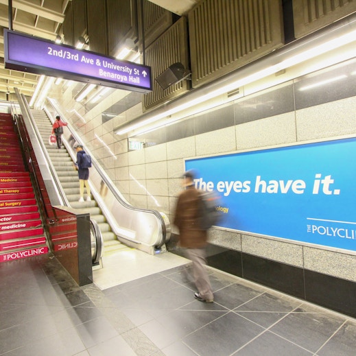 Passengers pass by The Polyclinic station domination advertising in Seattle's Union Station