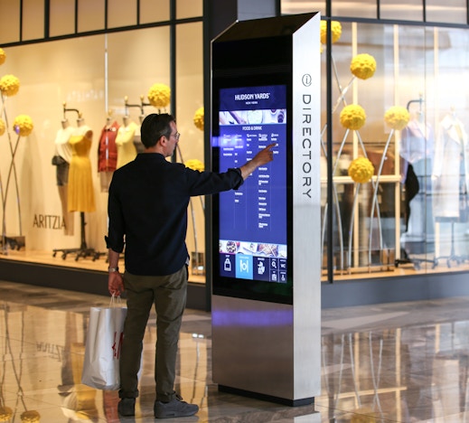 Shopper browses directory on IxNTouch kiosk at Hudson Yards