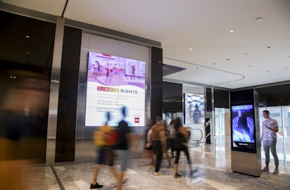 Visitor interacts with IxNTouch kiosk in Hudson Yards