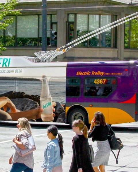 outdoor transit mockup ad in city with people walking by seeing out of home advertising on bus