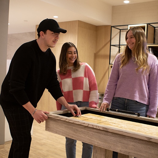 Intersection, Out of Home Media Agency NYC office with three employees playing games and laughing